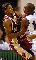 Ryan Sidney battles for the ball against Holy Cross' Jave Meade during the first half.
