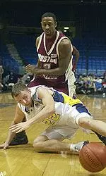 Troy Bell and Kent State's Eric Haut watch the basketball bounce away during the first half.