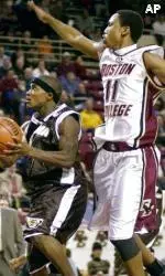 Guard Louis Hinnant leaps for a block as St. Bonaventure guard Marques Green drives to the basket during the first half.