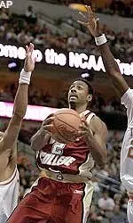 Boston College's Troy Bell splits Texas defenders James Thomas, and Royal Ivey, as he heads to the basket in the second half Friday.