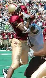 Wide receiver Jamal Burke wrestles the ball away from a Central Michigan defender for a touchdown in the first half of play.