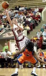 Jessalyn Deveny jumps over Syracuse's Krystalyn Ellerbe as she takes a shot in the first half.