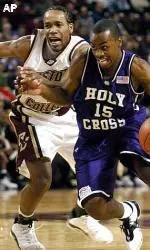 Jermaine Watson guards Holy Cross's Jave Meade in the first half.