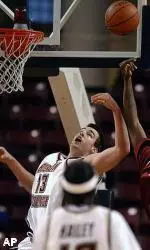 Nate Doornekamp battles for a rebound amidst UMass defenders during the first half.