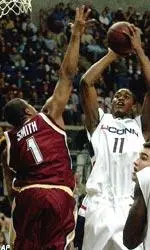 Craig Smith blocks a shot by UConn's Hilton Armstrong in the first half.