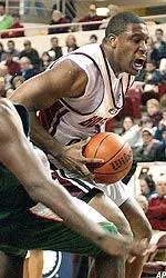 Craig Smith drives in for a shot during the first half.