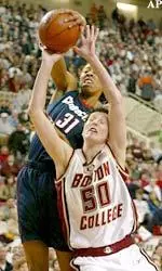 Kim Mackie battles for a rebound against Connecticut's Jessica Moore during the first half.
