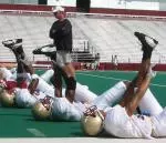 BC Head Coach Tom O'Brien watches as the Eagles stretch Sunday afternoon in Alumni Stadium. The team practiced in full pads for the first time.