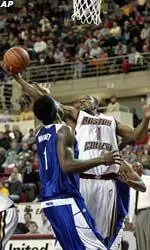 Boston College's Craig Smith grabs a rebound over Seton Hall's Kelly Whitney during the first half.