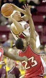Sean Marshall drives toward the basket over NC State's Scooter Sherrill