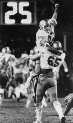 Quarterback Doug Flutie is hoisted into the air by his teammate, the late Steve Trapilo, following the most famous throw in college football history.