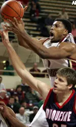 Craig Smith grabs a loose ball as Duquesne's Sean McKeon tries to stop him.