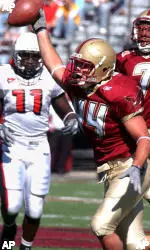Boston College's Jamie Silva reacts after his picked up a blocked punt during the first quarter against Ball State, Saturday, Oct. 1, 2005 in Boston. Ball State's Wendell Brown is at back left and Boston College's Kevin Akins is at back right. (AP Photo/Lisa Poole)