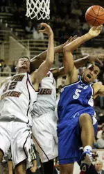 Buffalo's Yassin Idbihi can't control the rebound as Boston College's John Oates and Craig Smith also go for it during the first half.