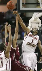 Craig Smith blocks a shot by Harvard's Evan Harris.