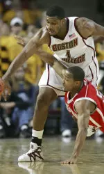 Sacred Heart's Tavio Hobson and Craig Smith battle for a loose ball.