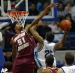 Boston College's Sean Williams goes up to block a shot by Rhode Island's Will Daniels during their NCAA basketball game in South Kingstown, R.I., Saturday, Dec. 31, 2005. Boston College won, 78-56. (AP Photo/Joe Giblin)