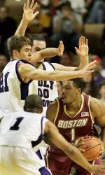 Craig Smith looks for room to pass around the defense of Holy Cross' Torey Thomas, Alex Vander Baan.