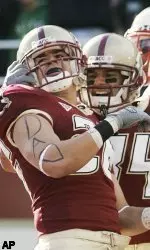 Boston College's Tony Gonzalez, left, and Kevin Challenger celebrate after Gonzalez scored a touchdown in the second quarter of college football game against Maryland, Saturday, Nov. 18, 2006, in Boston. Maryland's Marcus Wimbush is at right. Boston College won 38-16. (AP Photo/Michael Dwyer)