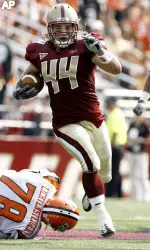Jamie Silva returns an interception 65-yards for a touchdown. (AP Photo/Winslow Townson)