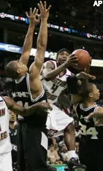 Tyrese Rice drives to the basket between Providence's Johnathan Kale and Geoffrey McDermott during the first half.