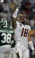 Boston College receiver Rich Gunnell, points upward after catching a 29-yard touchdown pass against Michigan State during the first half