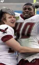 Senior captain Jolonn Dunbar (right) celebrates BC's win in the Meineke Bowl with kicker Steve Aponavicius.
