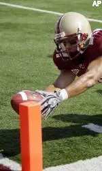 North Carolina State's Jeremy Gray hangs onto Boston College's Kevin Challenger as he dives into the end zone for a touchdown in the first quarter of a football game, Saturday, Sept. 8, 2007, in Boston. (AP Photo/Michael Dwyer)