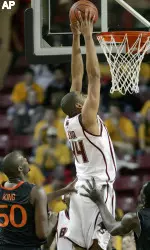 Tyrelle Blair dunks between Miami's Anthony King and Dwayne Collins during the first half.