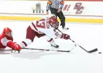Cam Atkinson is prepared to beat Wisconsin goalie Shane Connelly with a backhand for his first collegiate score as he is hauled down by defenseman Eric Springer.