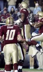 Donnie Fletcher celebrates his touchdown with teammates as quarterback Chris Crane comes in during the first quarter. (AP)