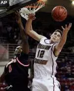 Forward Joe Trapani, right, reaches for the rebound against St. John's forward Sean Evans in the first half.