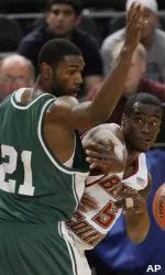 Biko Paris passes the ball off around UAB forward Lawrence Kinnard.(AP Photo/Julie Jacobson)