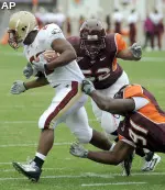 Virginia Tech's Barquell Rivers (52) and John Graves (91) stop Boston College's Rolandan Finch during the first half. (AP Photo/Don Petersen)