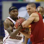 Tyrese Rice, left, and Southern California's Daniel Hackett battle for a ball. (AP)