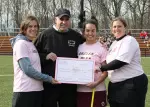 Coach Holden presents the Fitpatrick family a check in memory of Joanne Fitzpatrick