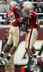 Justin Jarvis (82), Rich Gunnell, center, and Colin Larmond, Jr., celebrate in the end zone after Gunnell scored a touchdown during the first half. (AP Photo/Mary Schwalm)
