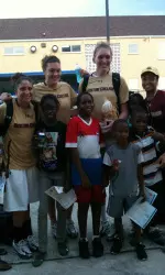 Carolyn Swords, Stefanie Murphy, Shayra Brown and Jaclyn Thoman celebrate with the kids watching the final at the Junkanoo Jam.