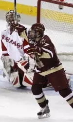 Brian Gibbons, foreground, celebrates a teammate's goal in front of Wisconsin goalie Scott Gudmandson during the first period.