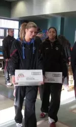 Alyssa Fressle and Shayra Brown start loading up boxes of food.