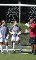 Assistant Coach Neel Bhattacharjee talks with Jillian Mastroianni and Jessica Mickelson about the next drill on Tuesday morning.
