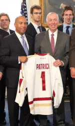 Jerry York presents Massachusetts Governor Deval Patrick with Boston College sweater inside the governor's office.