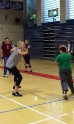 Lacrosse captain Mikaela Rix plays basketball with a Bridge Program student