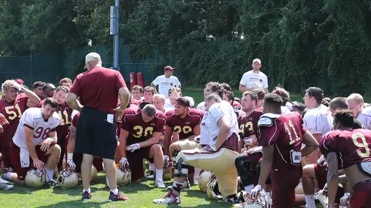 Football Team kneeling after practice