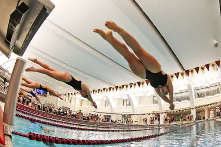 The women's swim team dives into the Connell Rec Center pool