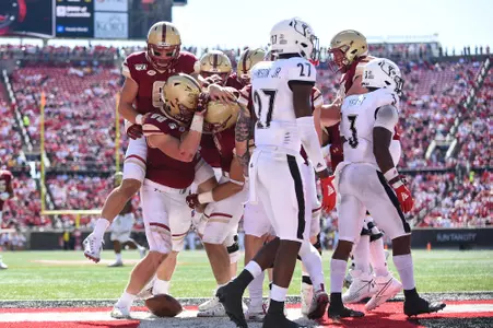 Dennis Grosel jumps on top of a touchdown celebration in the end zone against Louisville.