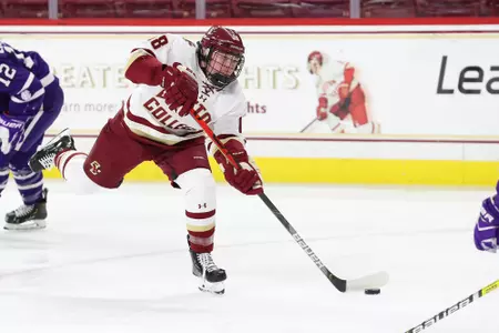 Kelly Browne shoots the puck against Holy Cross.