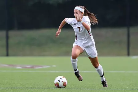 Gaby Carreiro dribbles the ball down the field.