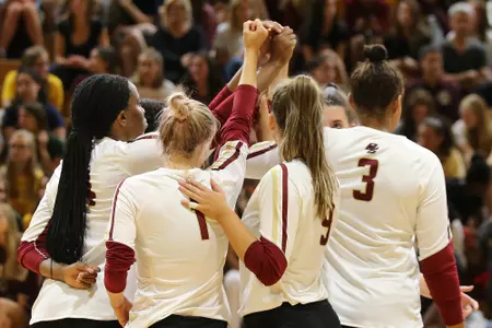 The volleyball team huddles against Northeastern