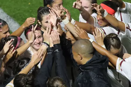 The team huddles before playing Miami.